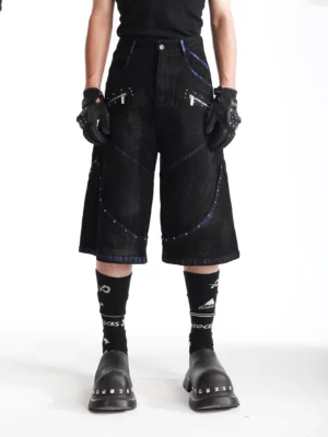 Ash blue studded wide-leg denim shorts front view styled with black tank top platform boots and streetwear accessories