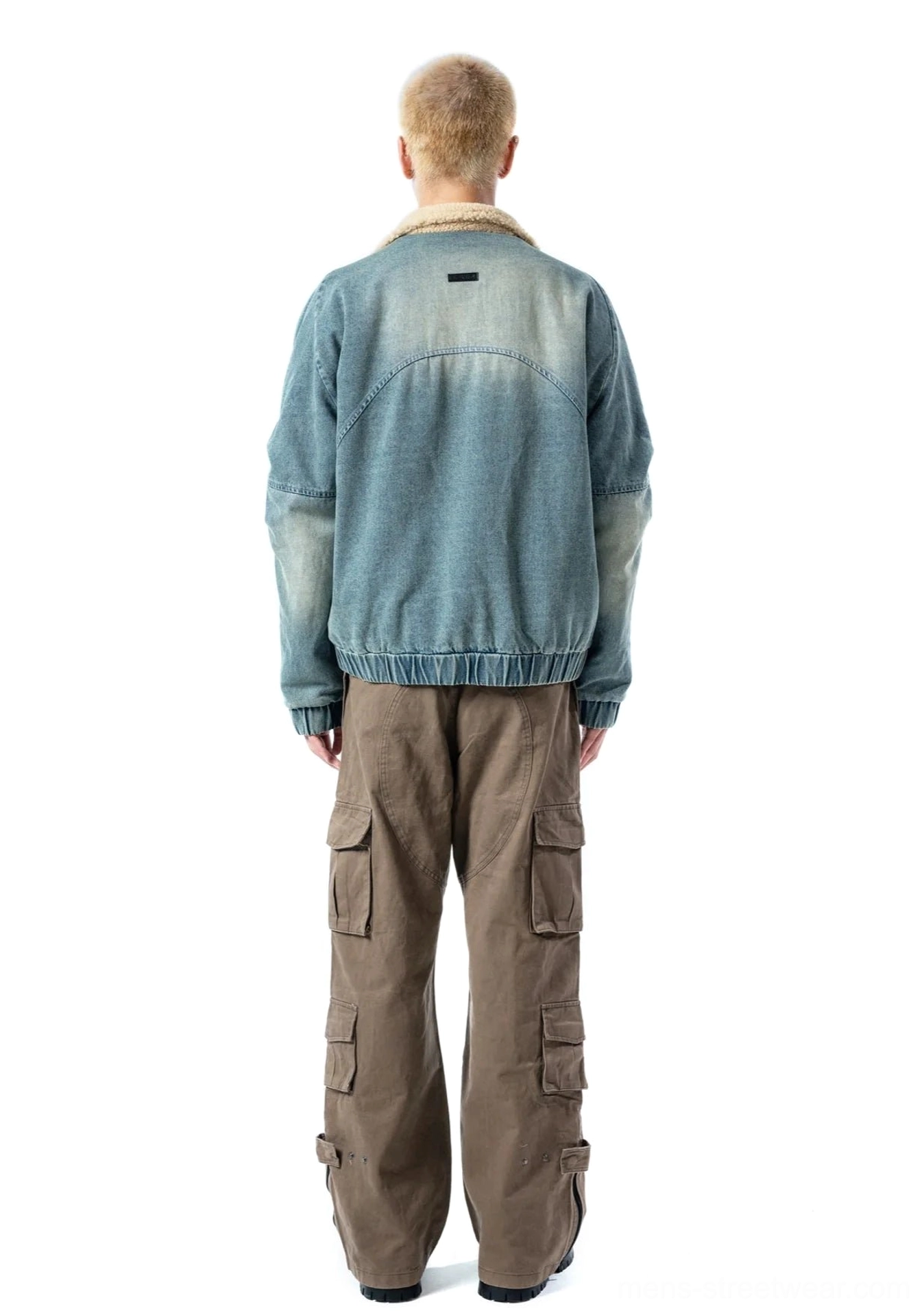 Full back view of ash blue washed denim bomber jacket with clean panelled back and elasticated hem