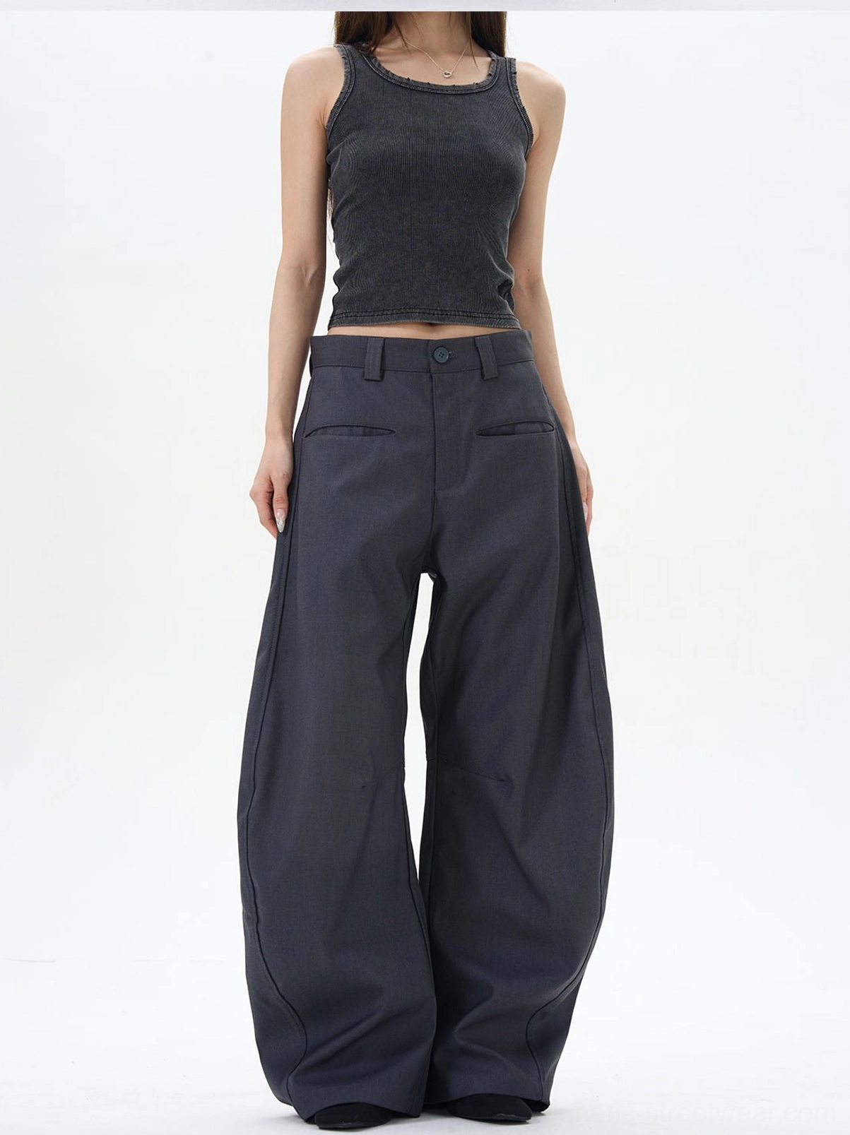 Ash dark grey wide-leg palazzo trousers with front tailored pockets and soft draping, styled in a minimalist studio