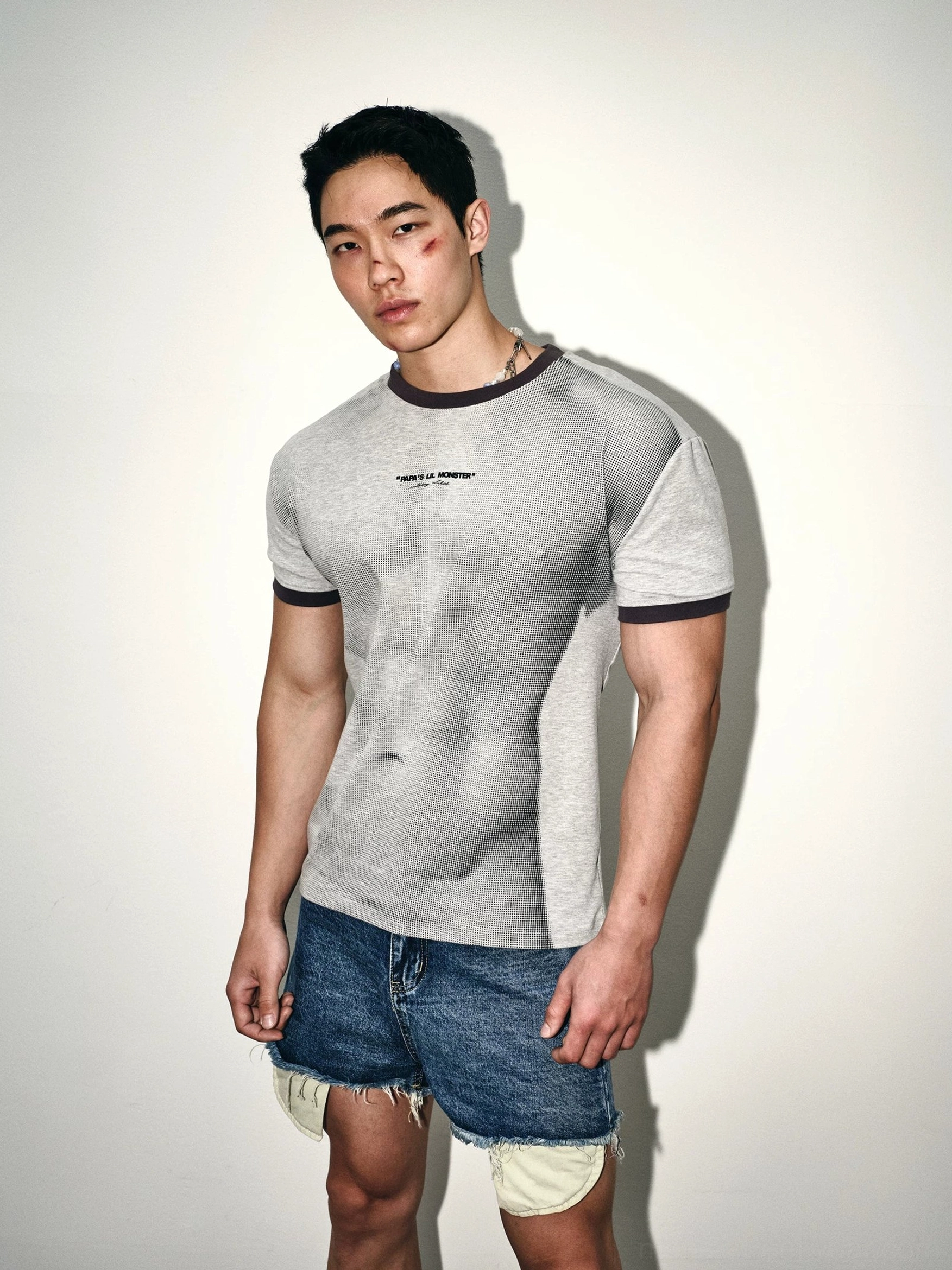 Ash gray ringer tee paired with distressed denim shorts in a full body Korean inspired streetwear outfit