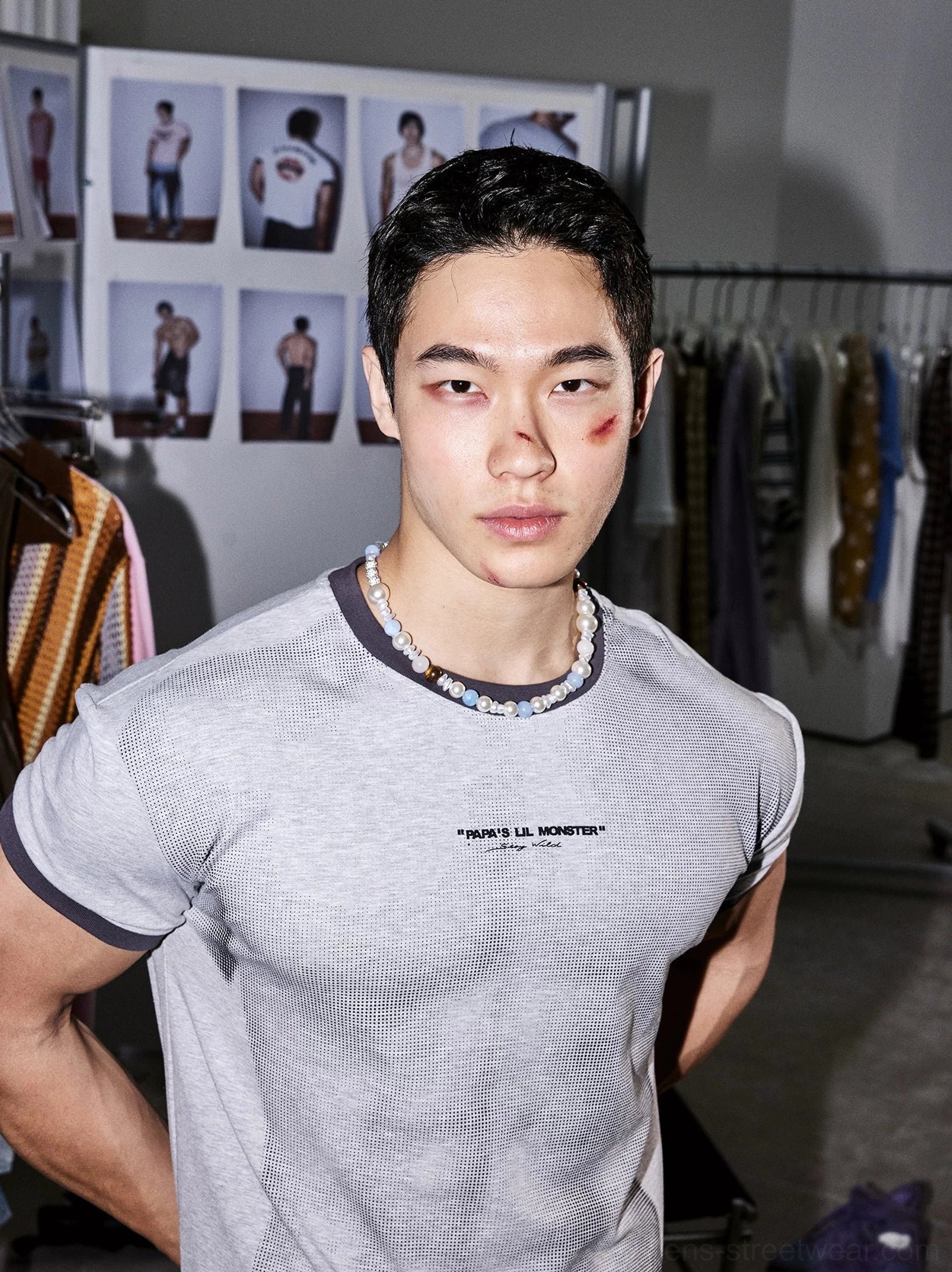 Close up front view of ash gray ringer T-shirt with small chest text graphic and beaded necklace styling