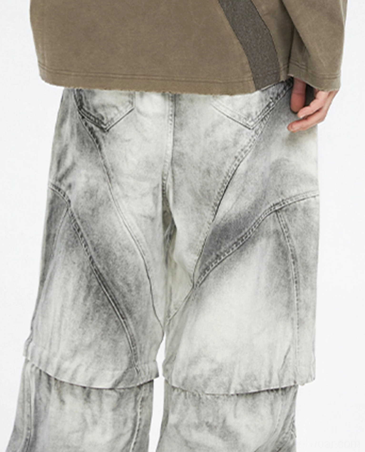 Front lower view of full length ash grey convertible cargo pants with detachable zipper seam, multi panel pockets, and loose wide legs