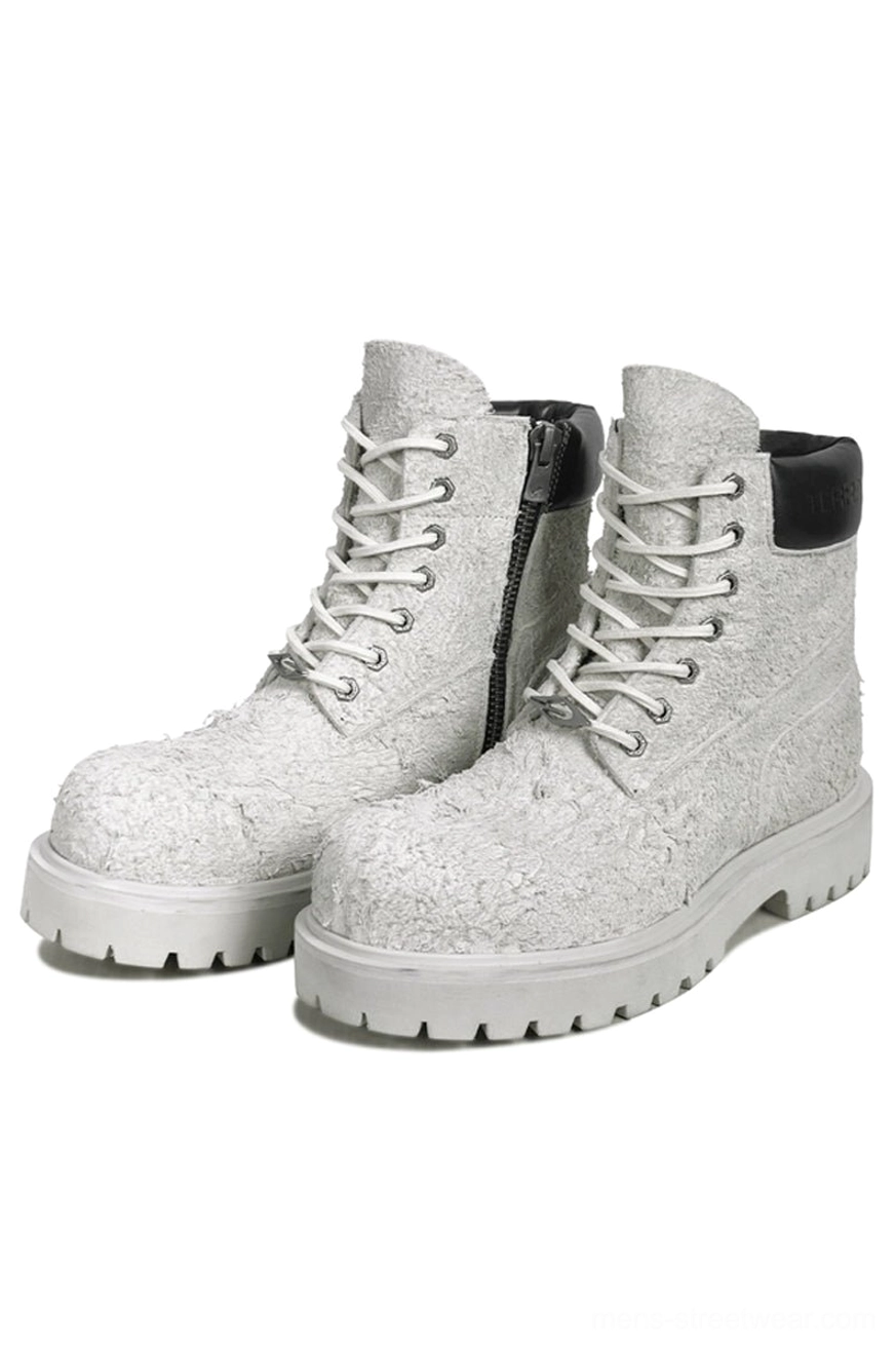 Ash off-white suede lace-up combat boots with chunky pale lug soles, shown in a front three-quarter studio view