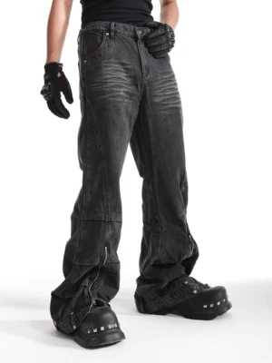 Left side view of ash washed deconstructed streetwear jeans showing panel seams, loose wide leg fit, and ankle zipper detail