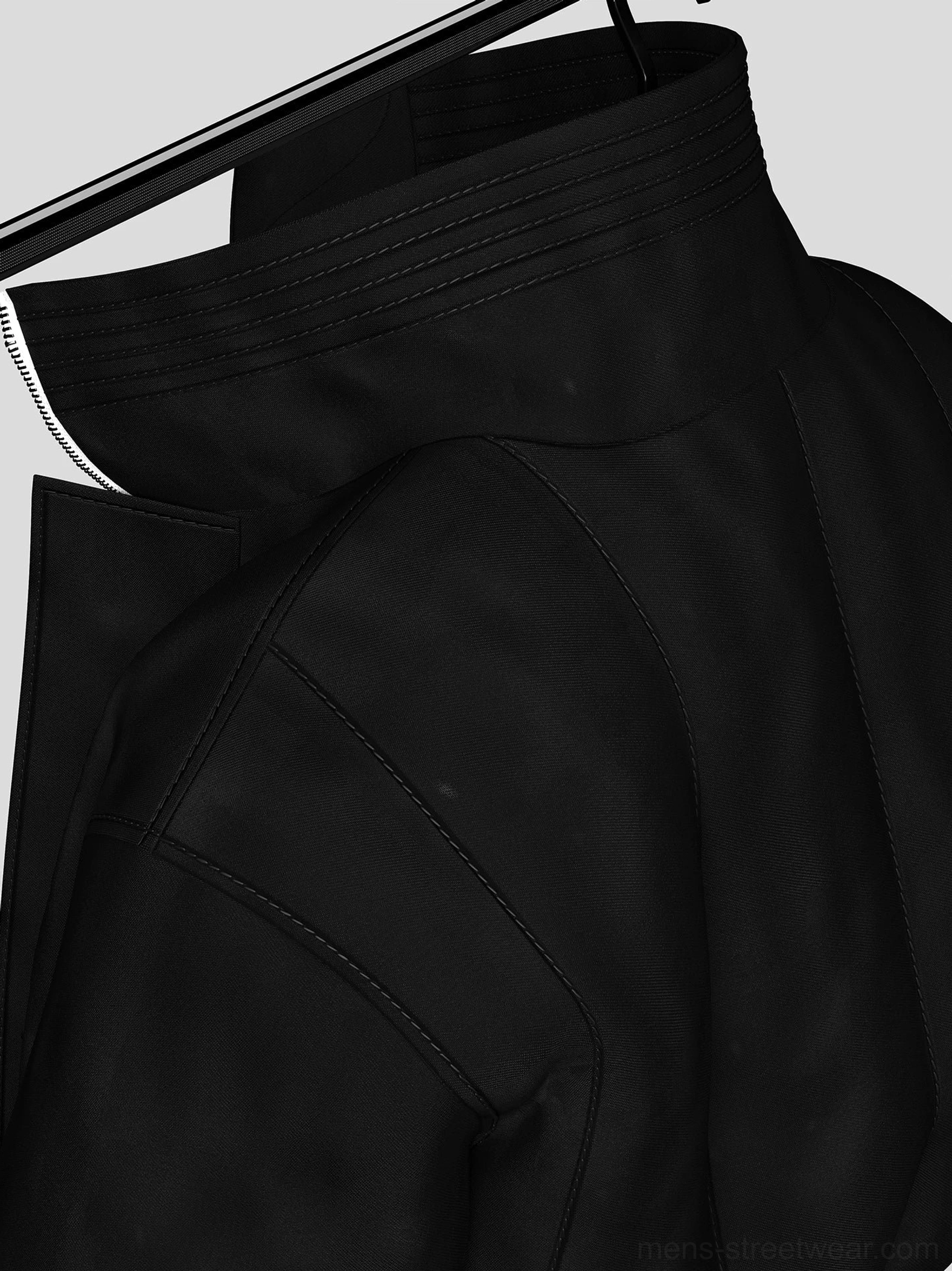 Close up detail of black woven bomber jacket shoulder, precision stitched seams, ribbed stand collar, and matte fabric texture