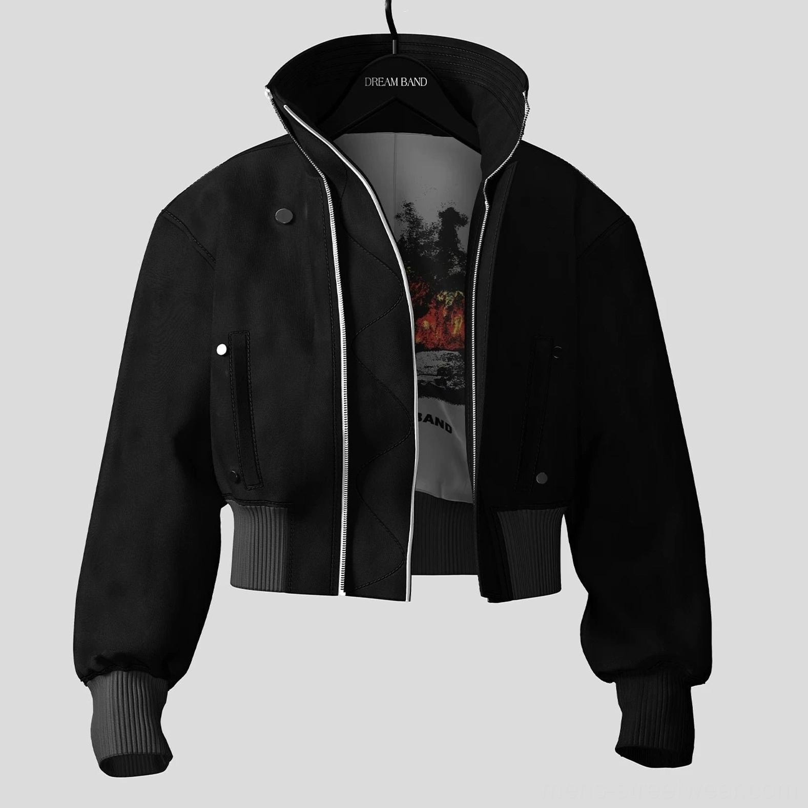 Front three quarter view of unzipped black cropped bomber jacket showing graphic inner lining, silver front zipper, snap pockets, and ribbed hem