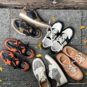 Assorted retro low-top horsehide leather sneakers displayed outdoors with autumn leaves showing multiple two-tone color variations and breathable casual styling