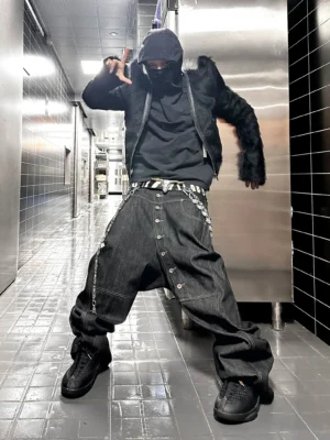 Low angle front view of asymmetric button fly wide-leg jeans in black Korean streetwear style with baggy drop crotch silhouette