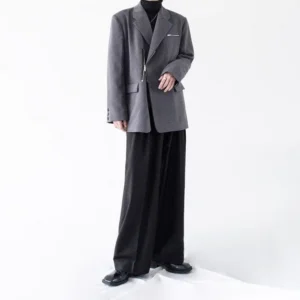 Side view of heather gray oversized asymmetric zipper blazer showing relaxed shoulders notch lapel and button cuff detail
