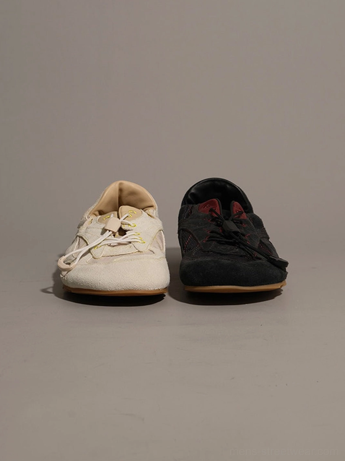 Avant-garde low-profile nubuck trainers with asymmetrical offset lacing, rounded toe, and mixed-material upper