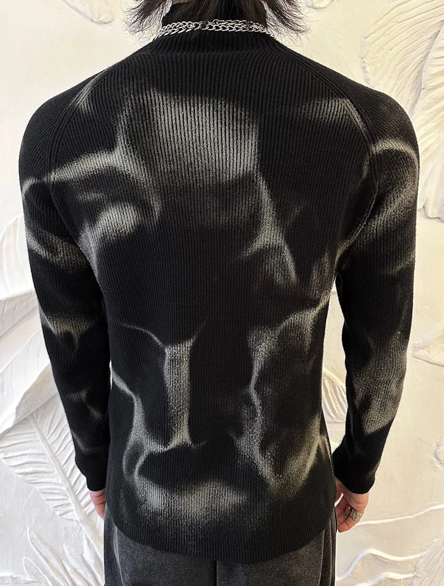 Back view of fitted black ribbed knit turtleneck sweater showing the abstract grey washed pattern and clean body-skimming cut