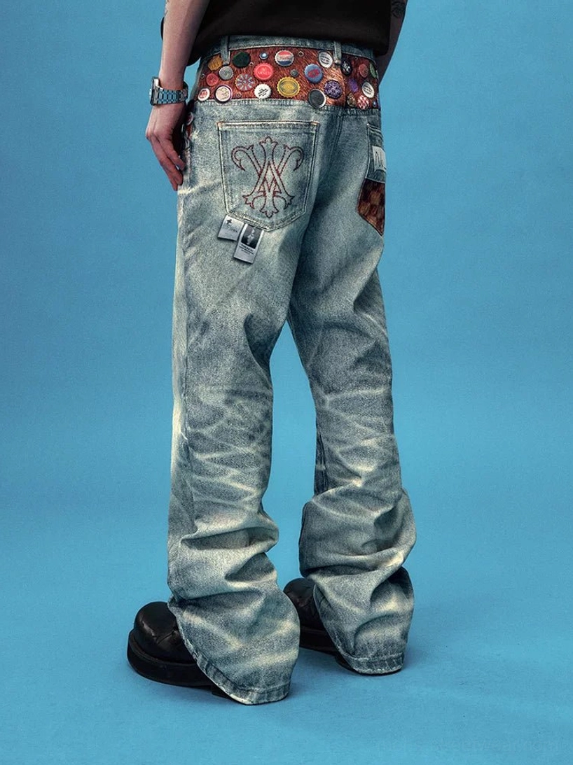 Side rear view of badge decorated washed wide leg jeans with leather look tassel chain and embroidered pocket