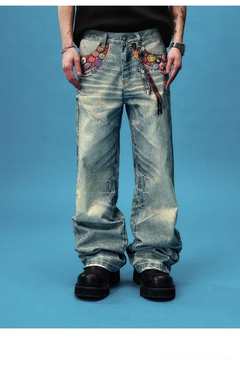 Front full body view of badge embellished acid wash wide leg streetwear jeans with tassel waist chain