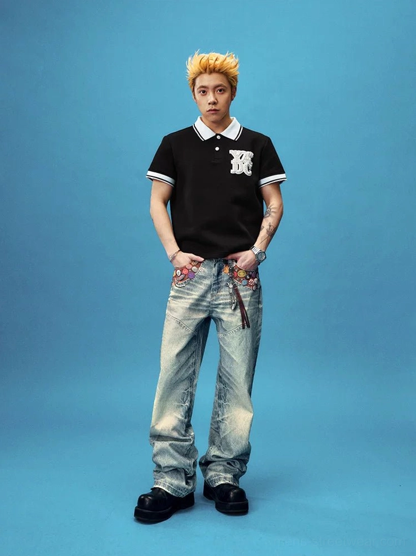 Streetwear outfit styling of badge embellished acid wash wide leg denim jeans paired with a casual polo shirt