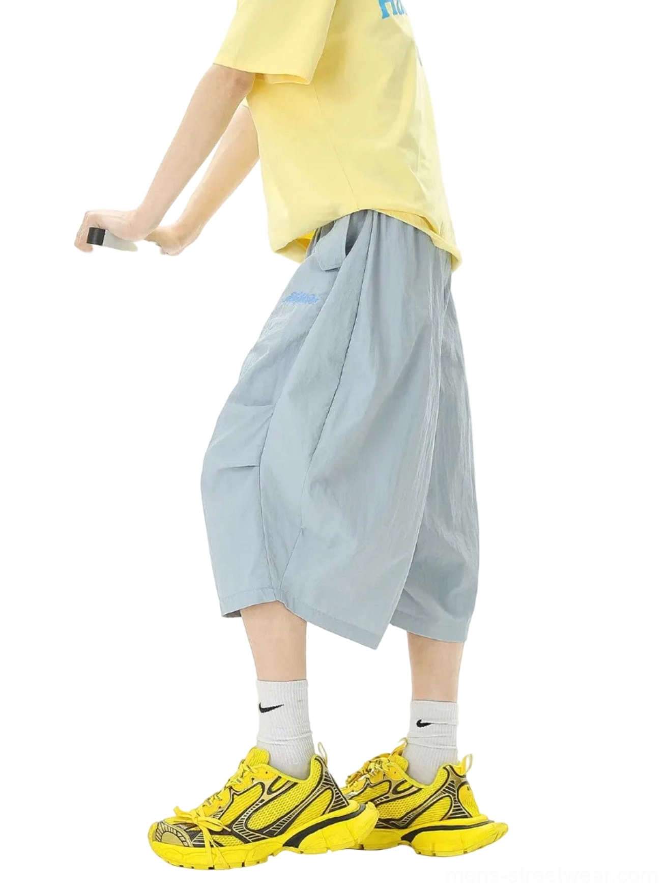 Rear side view of wide-leg balloon jogger shorts showing the cropped mid-calf silhouette side pocket and adjustable drawstring waist