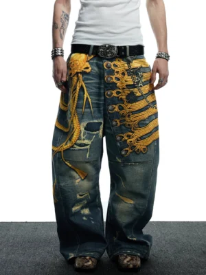 Front low-angle view of baroque military embroidered distressed wide-leg jeans with dark vintage wash and gold appliqué details