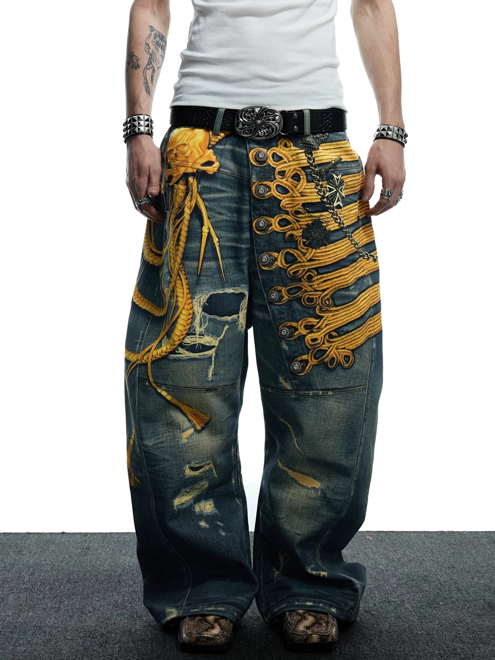 Front low-angle view of baroque military embroidered distressed wide-leg jeans with dark vintage wash and gold appliqué details