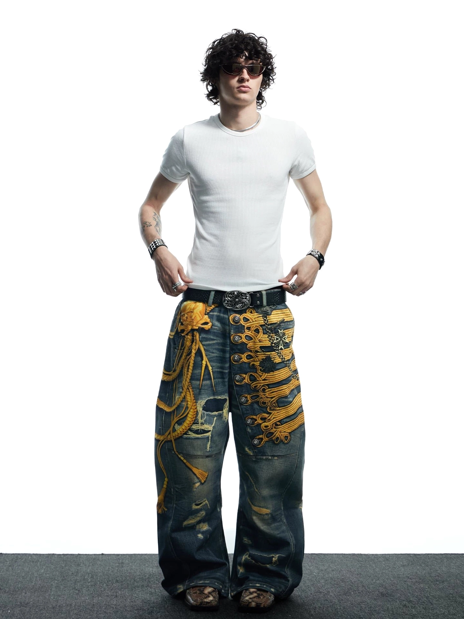 Full front outfit view of men's baroque military embroidered distressed baggy wide-leg jeans in vintage washed denim