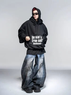 Black Be One’s True Self oversized streetwear graphic hoodie front full body view with white slogan print and dropped shoulders