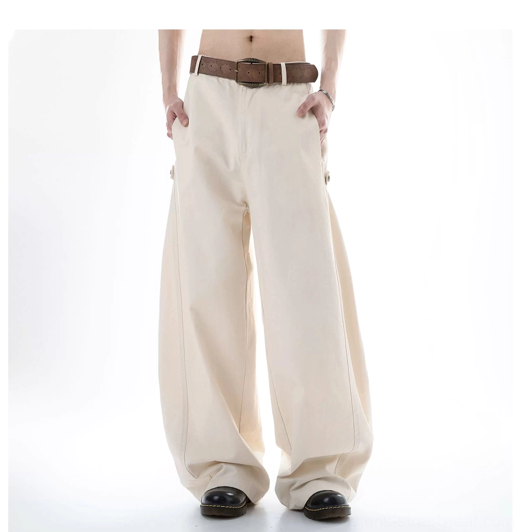 Beige Acubi wide-leg cargo pants shown from a rear-front angle with brown belt styling, wide legs, neutral cotton fabric, and side waist adjustment details
