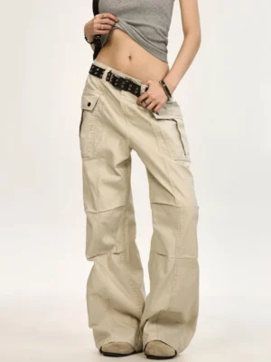 Beige low rise wide leg canvas cargo pants front view styled with cropped gray top and studded belt