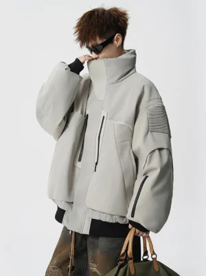 Light beige oversized tech puffer jacket side view with high stand collar sleeve zip pocket and textured arm panels