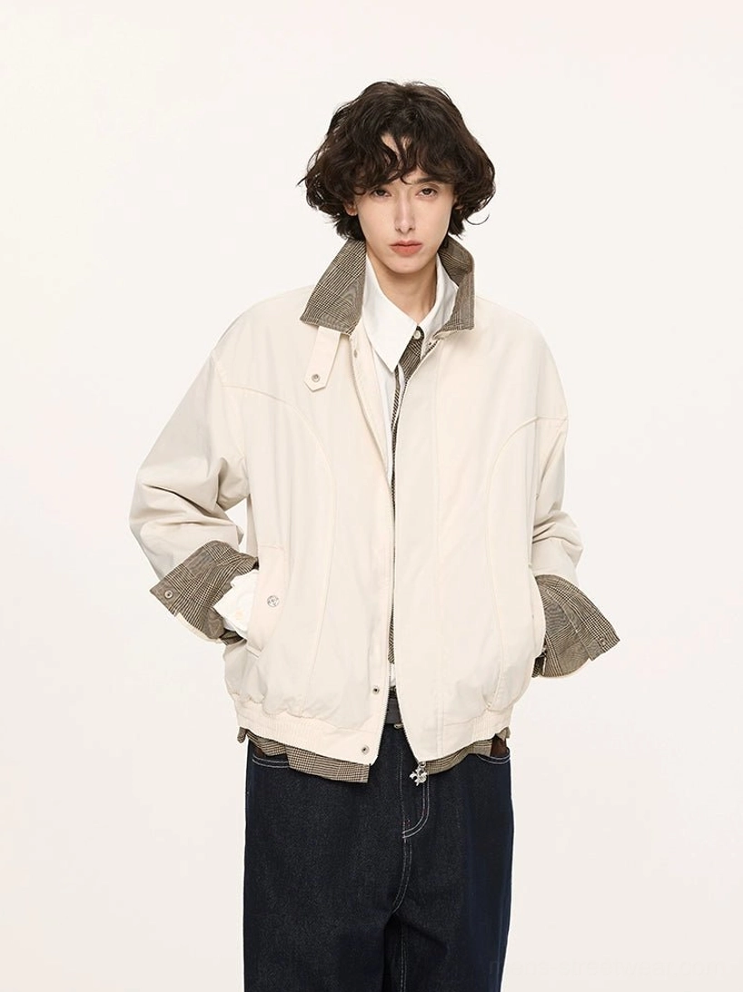 Beige plaid-lined Harrington jacket worn by male model showing clean minimalist outer shell and contrast turn-up cuff detail