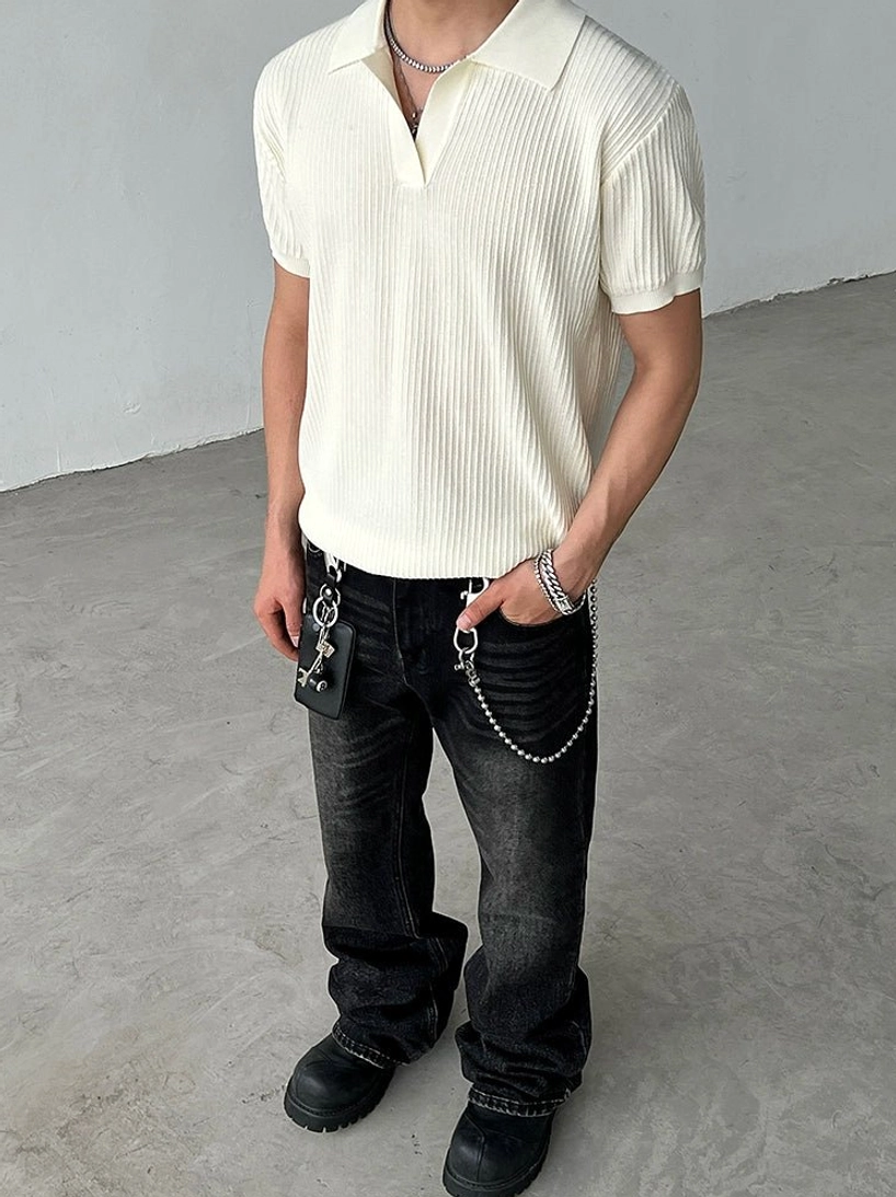 Cream beige relaxed-fit ribbed knit polo shirt with short sleeves styled with black washed jeans and chain pendants