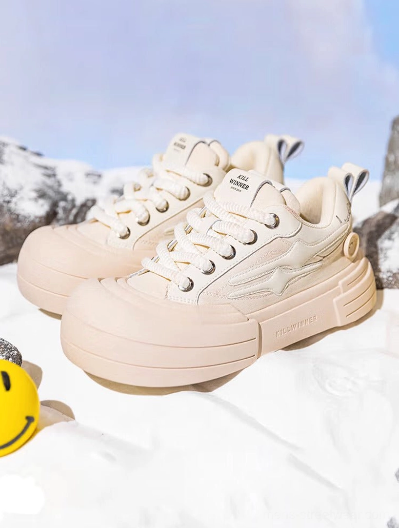 Pair of beige chunky platform sneakers shown from a front three-quarter angle with cream textile uppers, matching laces, smile streetwear styling, and subtle star details