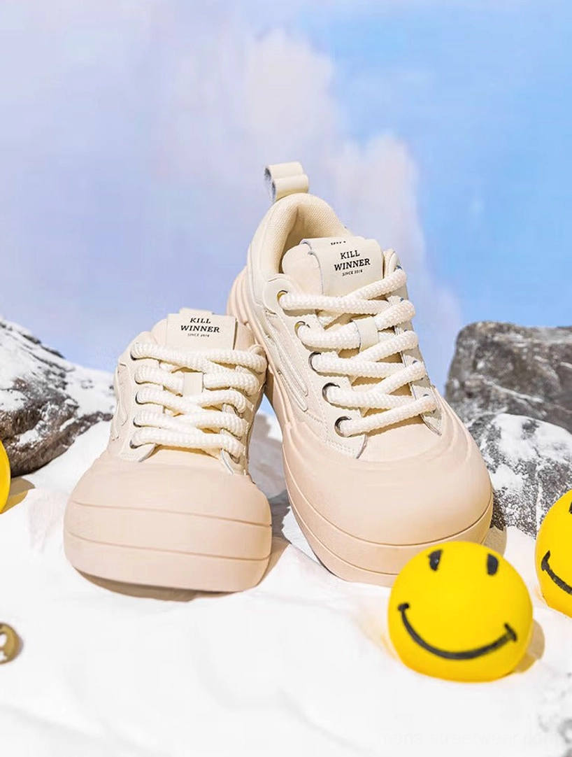 Pair of beige smile platform sneakers shown from the front three-quarter angle with rounded toe boxes, matching laces, and thick rubber soles