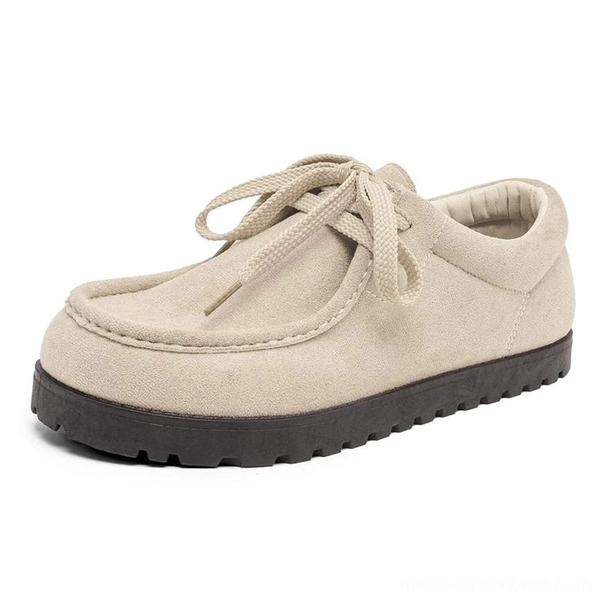 Beige suede square-toe lace-up shoes shown from the side with low-top silhouette and thick black ridged rubber outsole