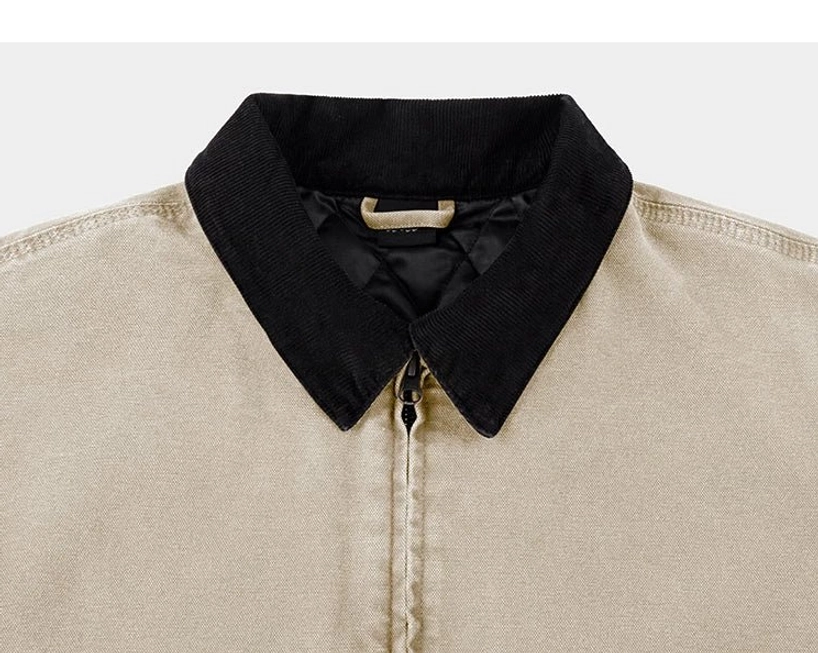 Beige cotton canvas work jacket close-up featuring a black corduroy pointed collar and centered metal zipper for modern streetwear styling