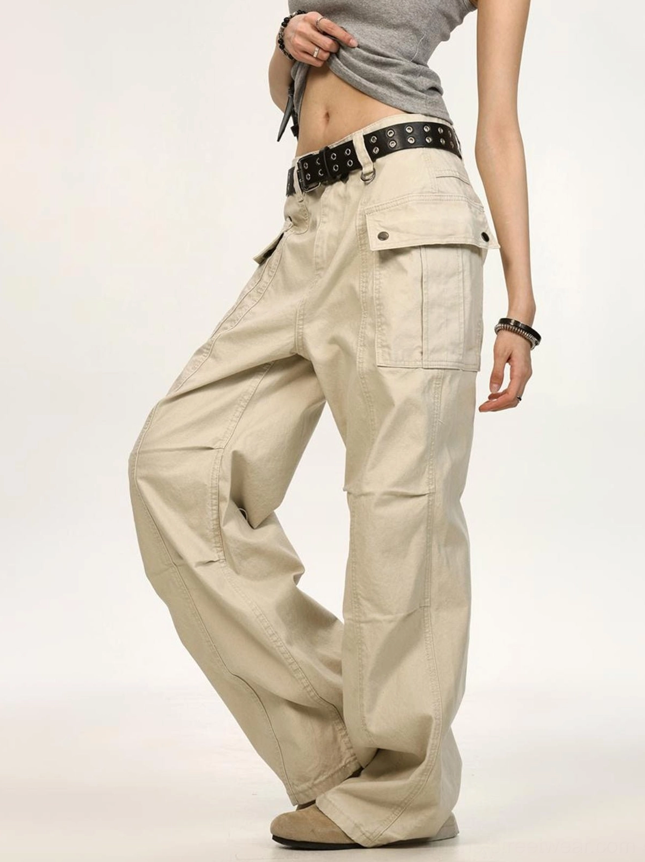 Beige washed canvas wide leg cargo pants side view with buttoned utility pockets and relaxed oversized streetwear fit