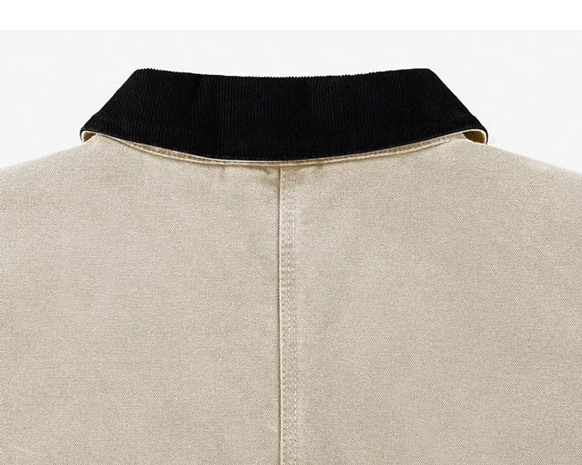 Beige work jacket upper back close-up with contrasting black corduroy collar, clean center seam, and structured cotton canvas finish