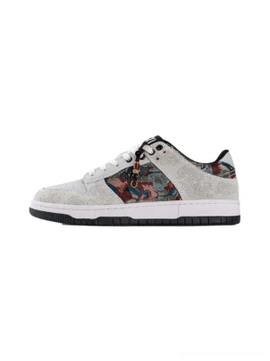 White bird embroidered brocade court sneaker shown in a front three-quarter product view with textured upper and black rubber outsole