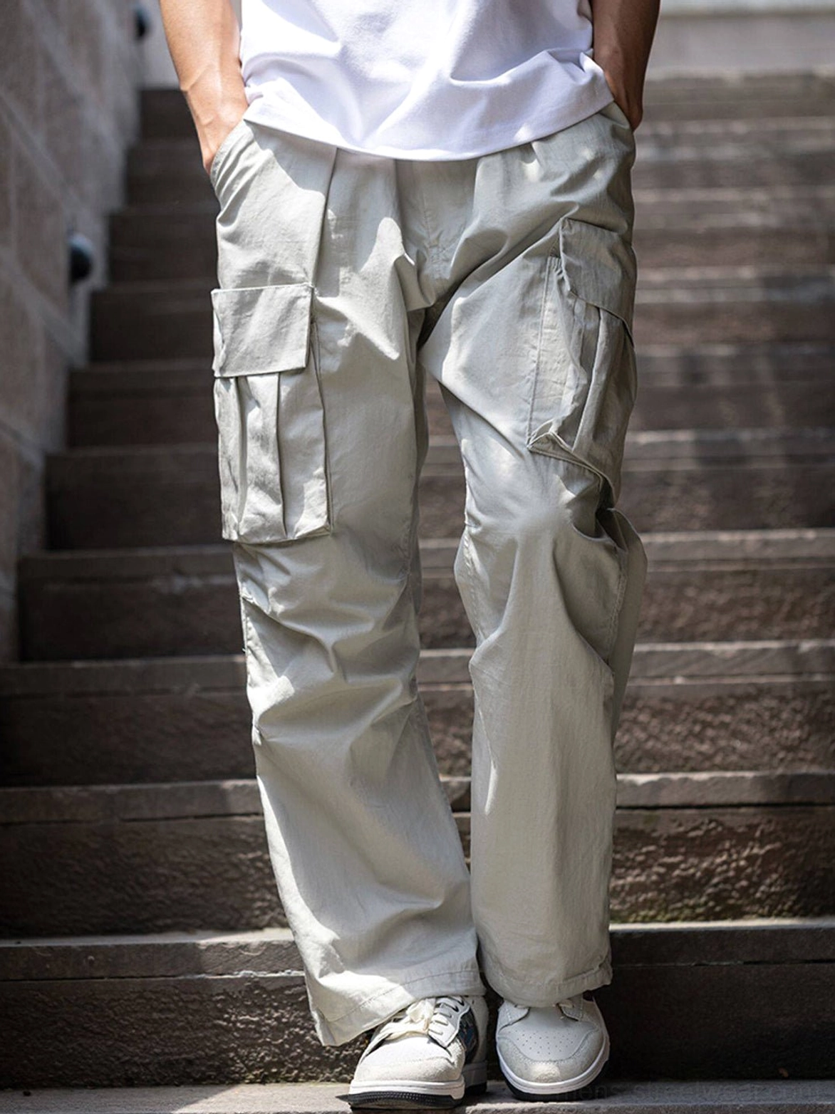 White embroidered brocade court sneakers styled with light grey cargo pants in a modern Korean streetwear outfit