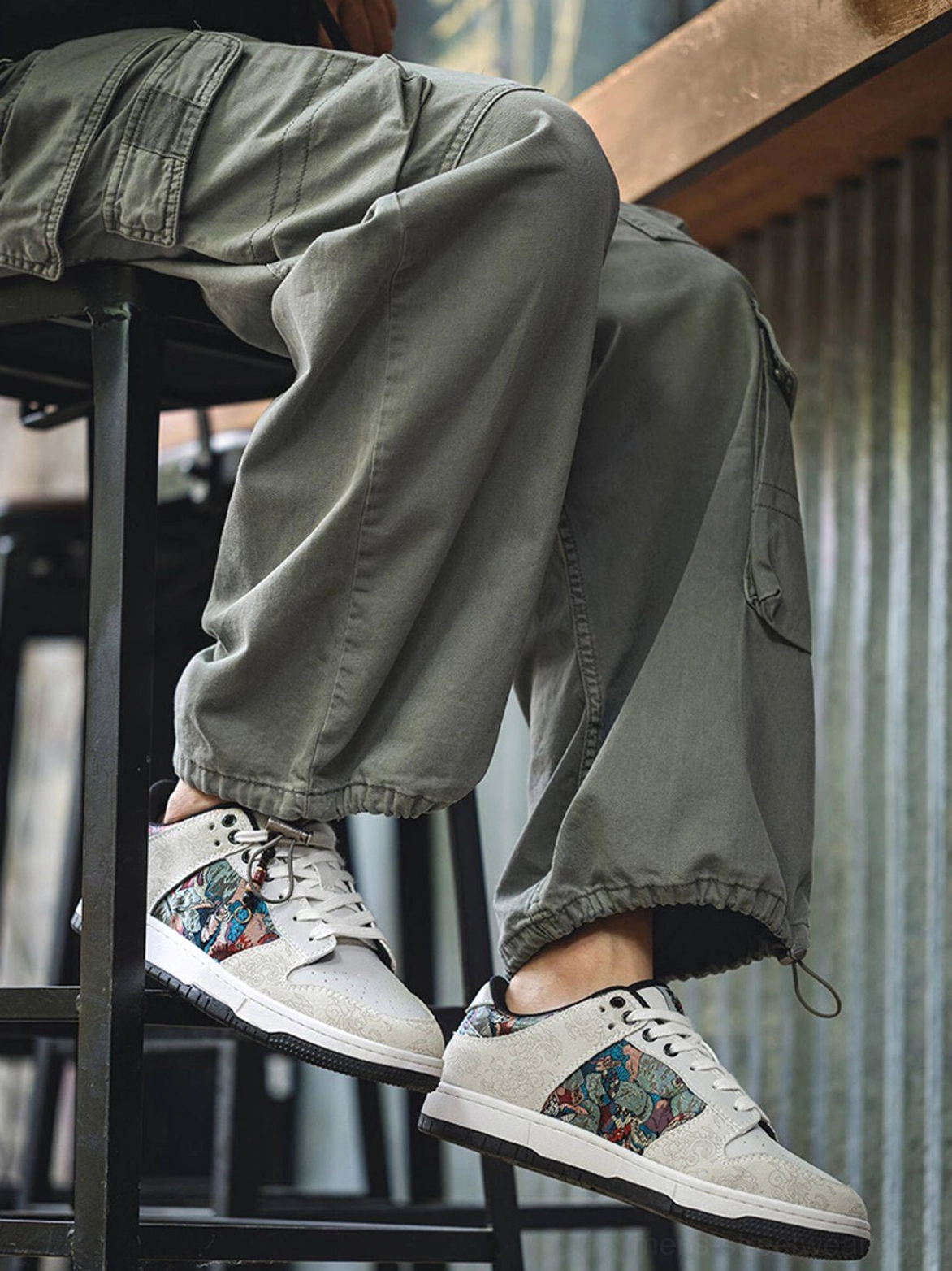 White bird embroidered brocade sneakers styled with relaxed olive cargo pants for an everyday streetwear look