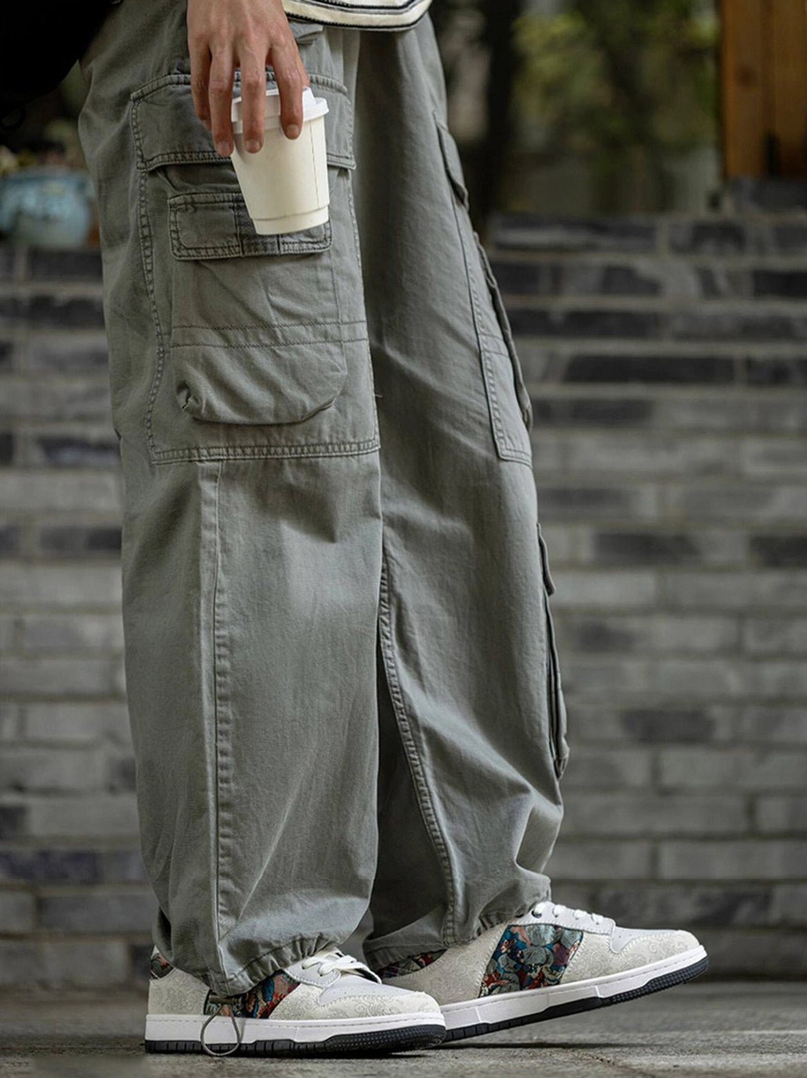 Bird embroidered white court sneakers worn with olive cargo trousers in a neutral Seoul-inspired casual outfit