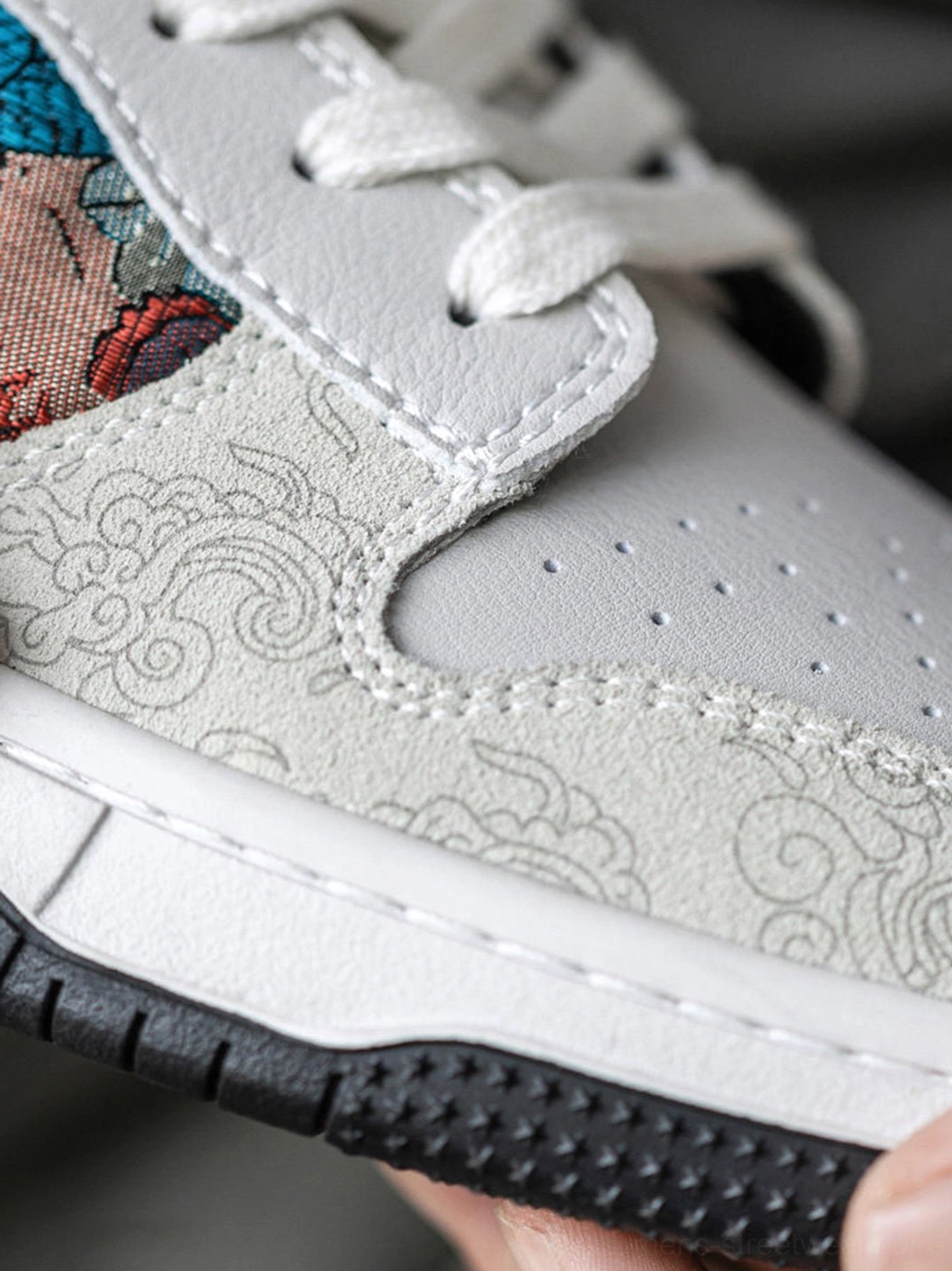 White embroidered court sneakers featuring oriental bird artwork, textured brocade panels, and unisex low-top styling