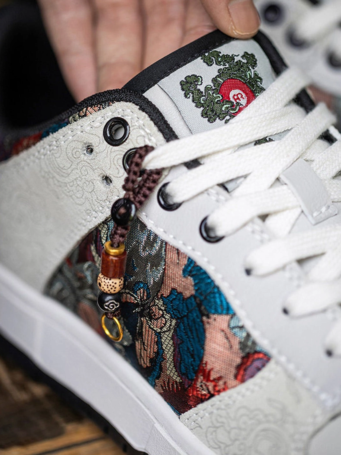 Unisex white bird embroidered sneakers with lace-up court profile and decorative brocade side detailing