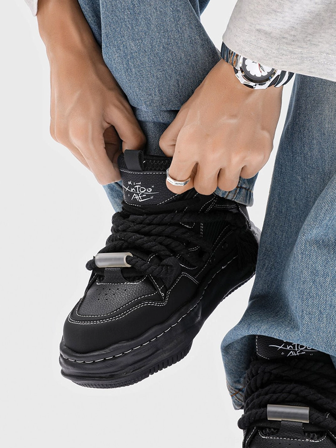 Black 7CM platform sneakers featuring twisted rope laces, metal toggle accents, contrast stitching, and a rounded unisex upper