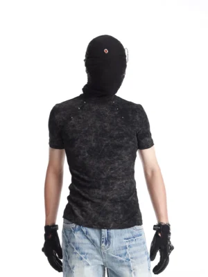 Rear view of a black acid washed fitted T-shirt with shoulder rivet details styled with light blue jeans in a minimalist studio