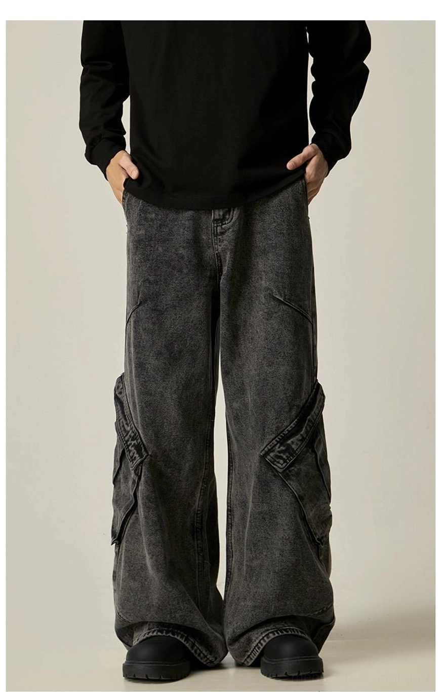Direct front view of black acid-washed wide-leg cargo jeans featuring a button closure waist and structured side utility pockets