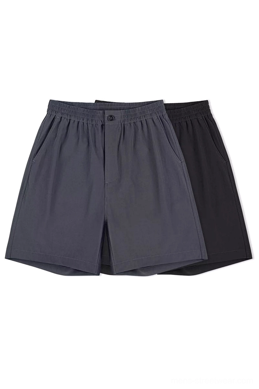 Black and dark gray cotton outdoor tech shorts shown together in angled flat lay streetwear product view