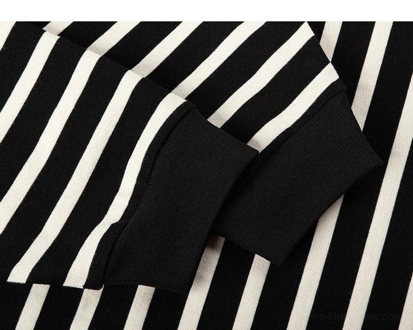 Close-up of the solid black ribbed sleeve cuff and clean stripe seam on a cotton Breton stripe streetwear tee