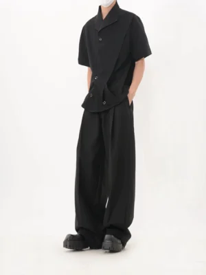 Black asymmetric cascade button shirt left side view with relaxed tailored wide leg trousers