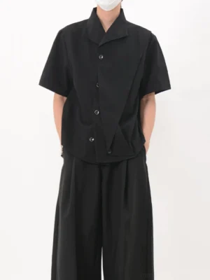 Black asymmetric cascade short sleeve shirt worn with wide leg trousers front full body streetwear outfit
