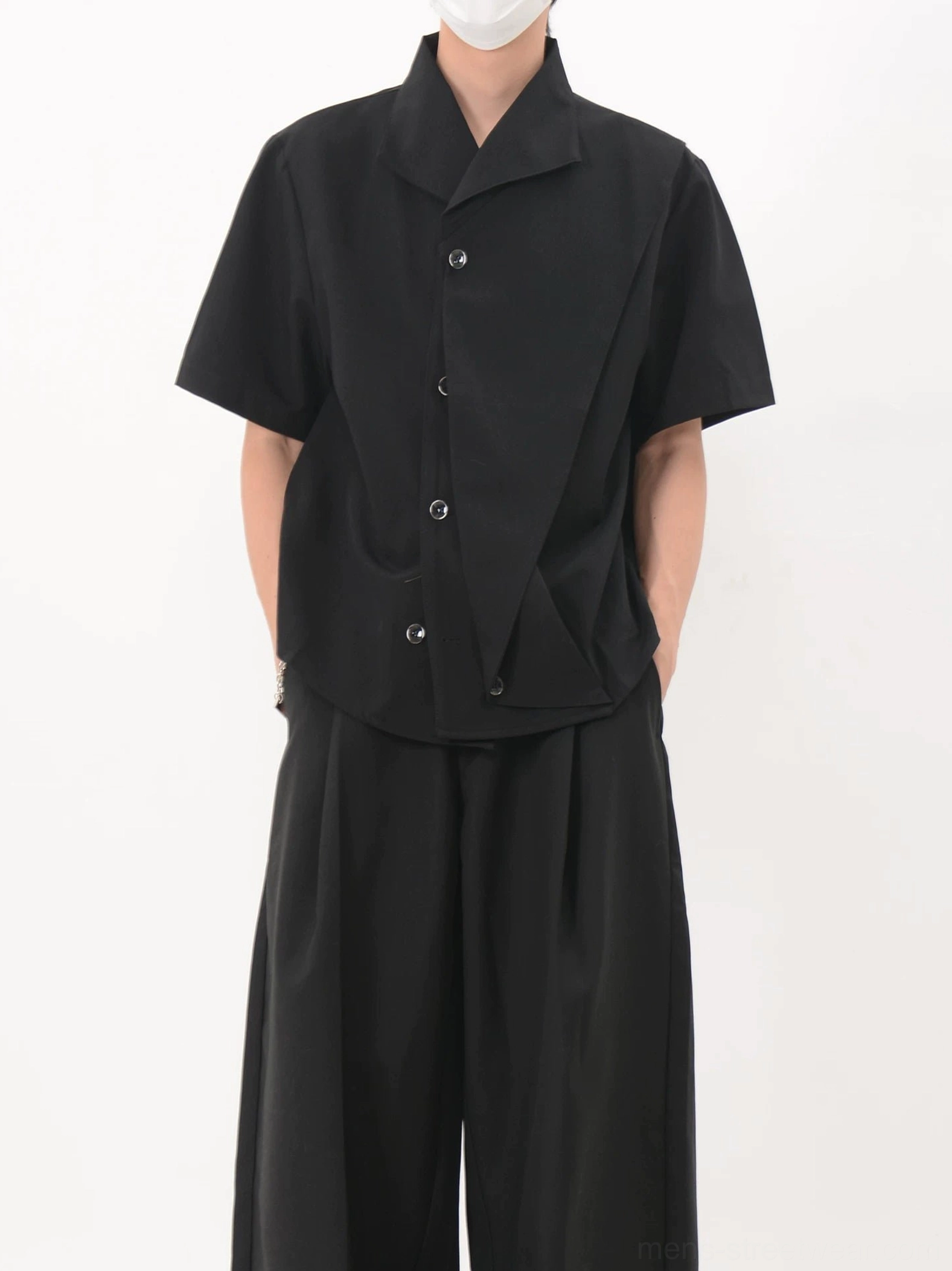 Black asymmetric cascade short sleeve shirt with off center button placket and layered front panel