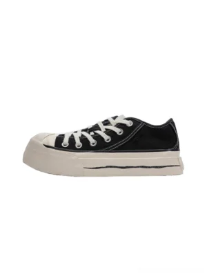 Black asymmetric toe platform canvas sneakers with white laces and vintage off-white rubber sole left side view