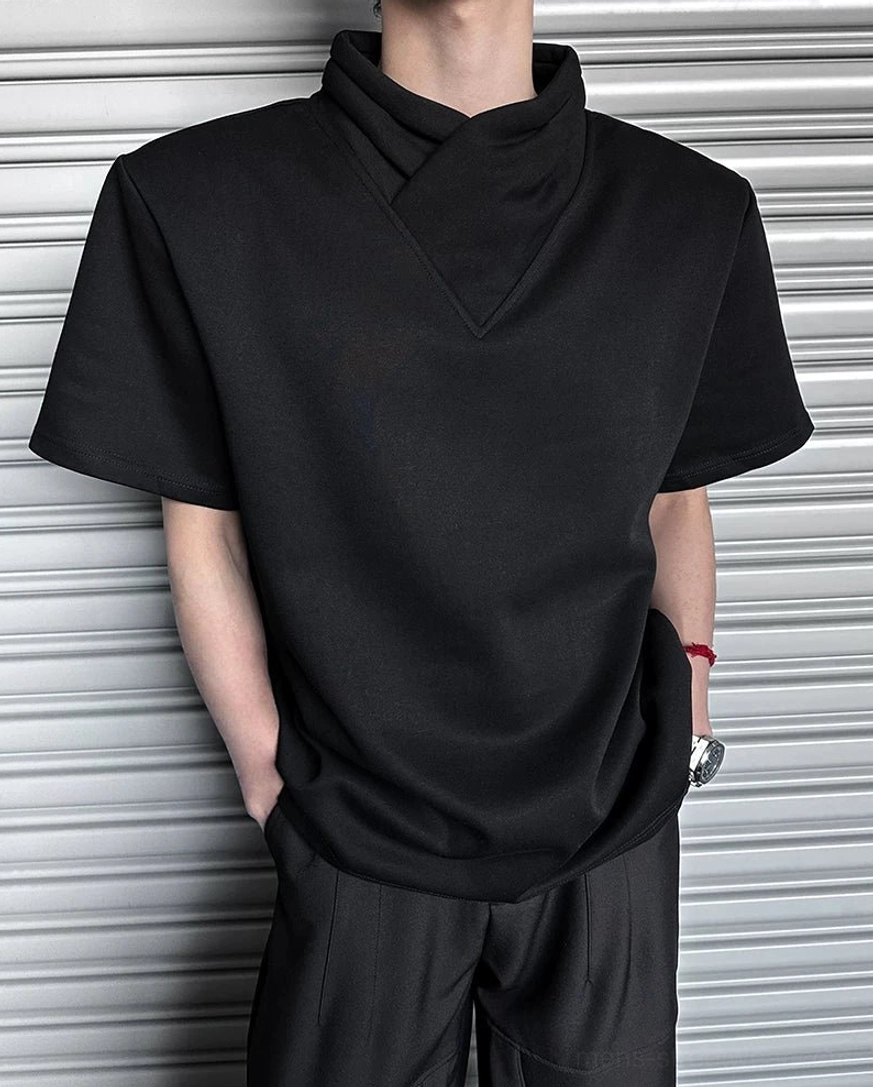 Close-up of black asymmetric V-front mock neck T-shirt collar with smooth cotton fabric and minimalist techwear street style